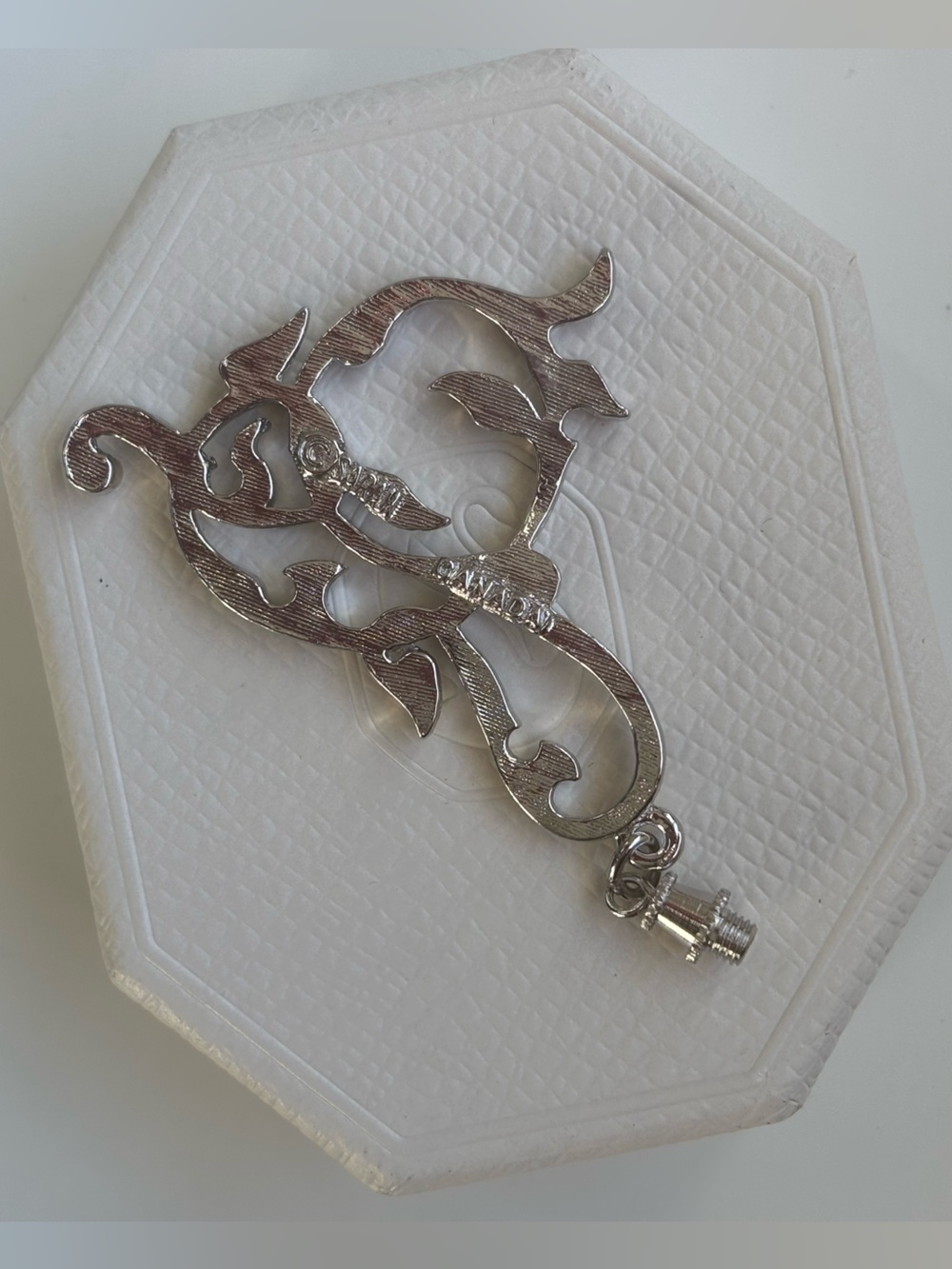 Silver tone metal pendant with screw top loop